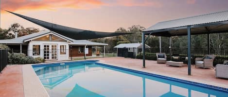 Cool down with a refreshing dip in the generous in-ground pool, or simply relax poolside with a good book in the undercover seating area.