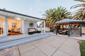 French doors open out to the backyard and patio, where you can sit a relax undercover.