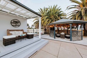 Enjoy the main house's cosy patio sofas while sipping on a glass of local wine.