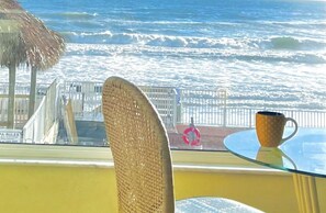 Dining table w picture window overlooking Tiki Bar, Beach & Pool