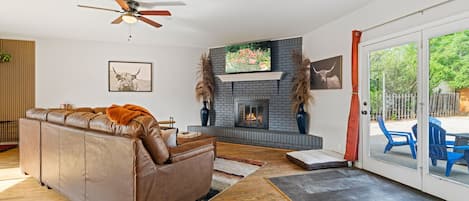 Living room with leather couch and fireplace