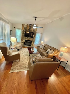 Living room with gas log fireplace and new smart TV