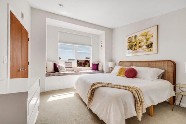 light and airy master bedroom with king sized bed