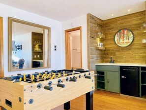 A foosball table and wet bar complete the hangout area.
