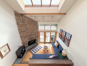 Living room with gas fireplace and deck with a propane grill.