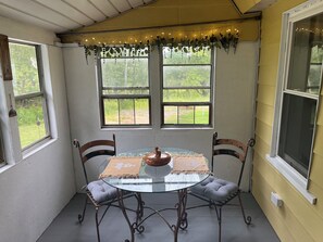 Enclosed side porch dining area