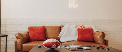 Sports-themed living room with leather couch