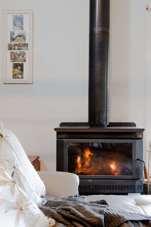 Cosy up with a wood fireplace in the lounge overlooking the trees