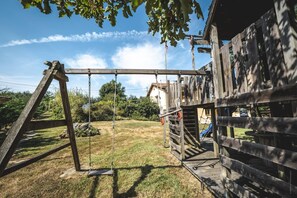 Outside: Large terraces - Tables - Charcoal BBQ - Above-ground swimming pool - Trampoline + Wooden play area for children. 