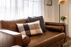 Cosy couches surround the combustion fireplace.  Loungeroom complete with smart TV, and dedicated workspace.  Free Wifi throughout property