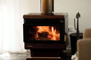 Cosy couches surround the combustion fireplace.  Loungeroom complete with smart TV, and dedicated workspace.  Free Wifi throughout property