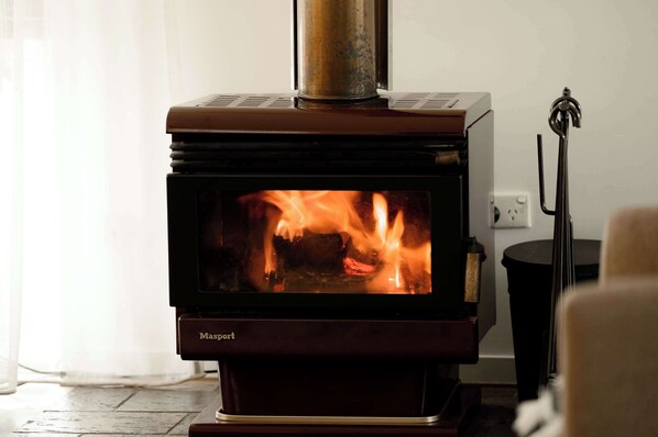 Cosy couches surround the combustion fireplace.  Loungeroom complete with smart TV, and dedicated workspace.  Free Wifi throughout property