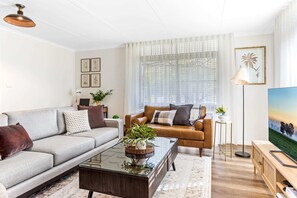 Cosy couches surround the combustion fireplace.  Loungeroom complete with smart TV, and dedicated workspace.  Free Wifi throughout property