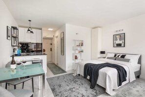 Another angle of the apartment highlighting the open layout, cozy seating, and decorative touches for a homely feel.