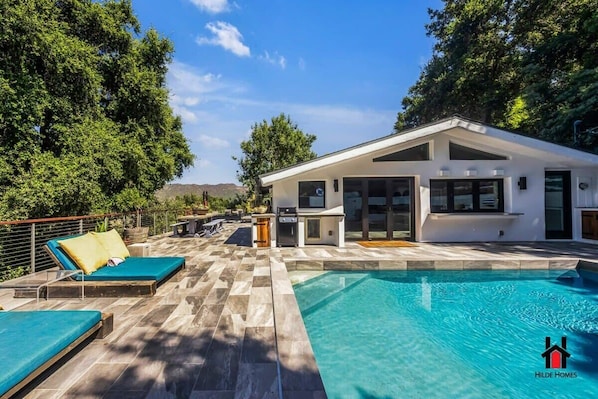 Cushioned sunbeds give it a resort vibe