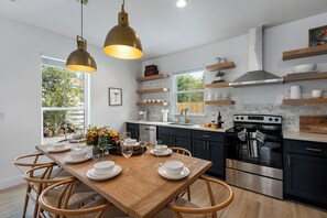 Large table opens to the kitchen to entertain.