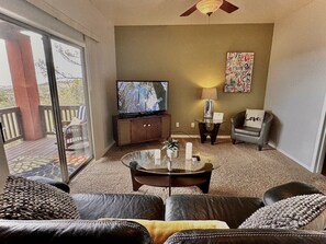 Living room with comfortable seating and cable + smart tv