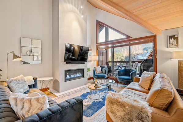Spacious open concept living room, dining room, and kitchen. Gas fireplace w/ remote, Smart TV w/ cable + Soundbar, brand new high end furniture featuring leather and velvet couches and accent chairs