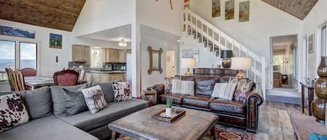 Upper living area - open to the dining area and kitchen, cozy couches and gas fireplace