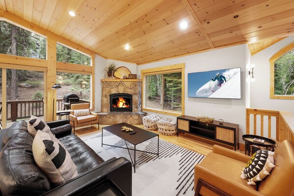 Modern spacious living area with TV and fireplace