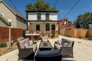 Lounge on the private patio featuring cozy seating, a fire table, and a soothing hot tub. Perfect for stargazing, cocktails, or catching up with friends and loved ones.