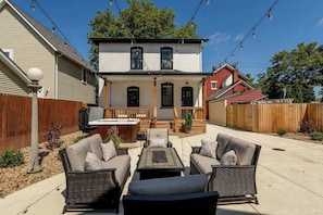 Lounge on the private patio featuring cozy seating, a fire table, and a soothing hot tub. Perfect for stargazing, cocktails, or catching up with friends and loved ones.