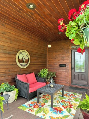 Enjoy the attached covered porch with comfy furniture