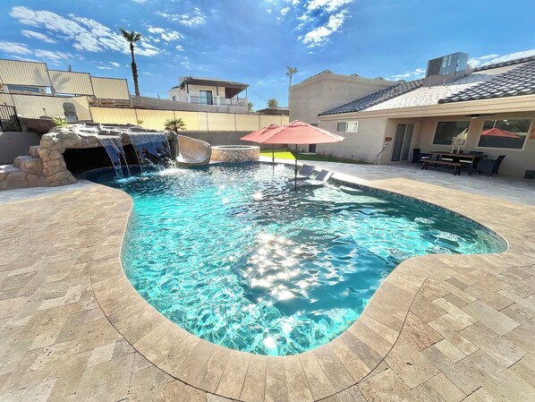 Custom pool. Huge baja shelf, 4 in-pool barstools, 44' water slide, grotto