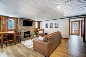 Dining table with seating for 4, electric fireplace and smart TV with cable.