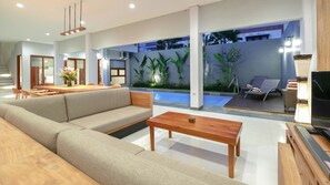 TV lounge area that open onto the outdoor space as a spot for family entertainment and lounge