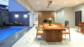 Dining area with clean modern layout by the private pool. Perfect for special dining in experience 