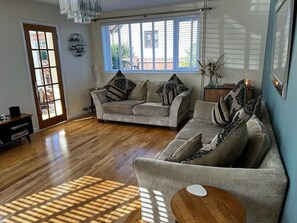 Comfortable room with a 4 and 3 seater sofa. Large flat screened TV with Netflix