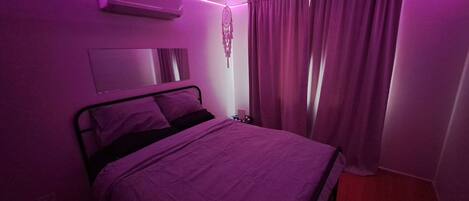 bedroom with changing colour ceiling lights connected with Alexa