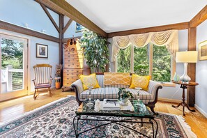 A Victoria sofa and Queen Anne Highboy decorate this sunny entry way. 