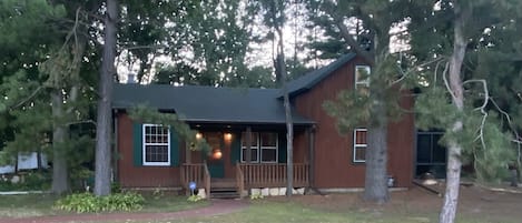 Front of home, deck with chairs to sit and relax.