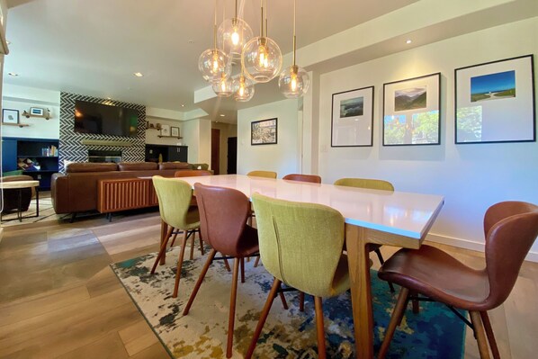 The dining table between the kitchen & living room showcases the open floor plan