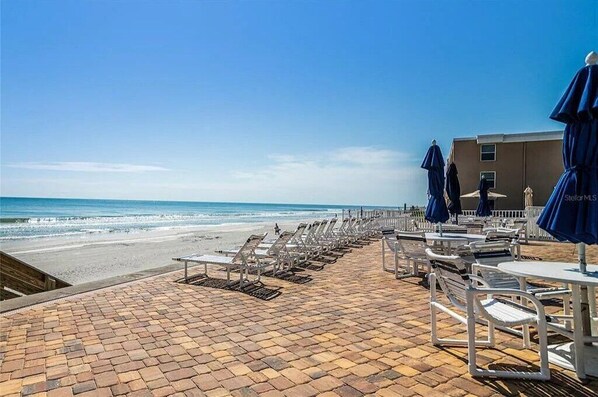 Lounge by the beach in our complex's complementary beach chairs!