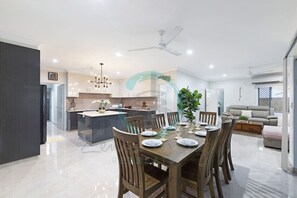 Zenhouse: 4BR Stylish Work/Family Home Experience seamless living and dining in our open-concept space, where the living area flows seamlessly into the dining area, creating a versatile and inviting environment perfect for relaxation and entertaining