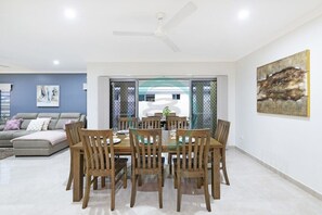 Zenhouse: 4BR Stylish Work/Family Home in Muirhead- Gather around our spacious dining table designed to accommodate up to eight guests, creating the perfect setting for memorable meals and lively conversations with friends and family.