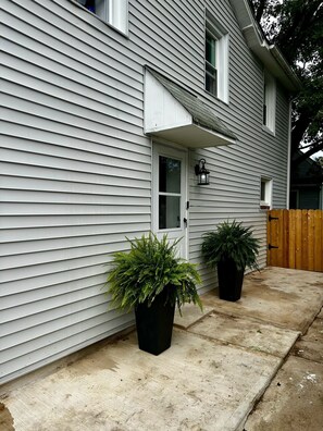 Property entrance and entrance planters. Spotlight on the top right of the door.