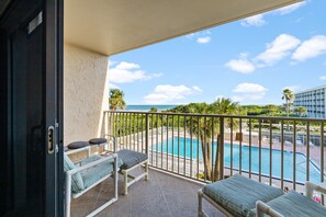Relax on your private balcony, perched above the pool and beach, and soak in breathtaking coastal views.