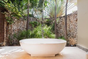 Tropical style bathtub in master suite