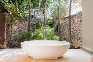 Tropical style bathtub in master suite