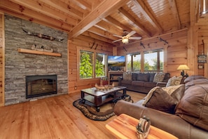 Open concept living room area w/ TV, electric fireplace