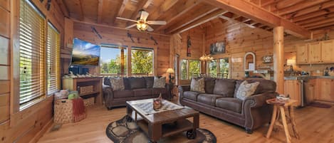 Open concept, spacious dining room area overlooking the wooded view