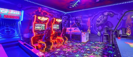 Incredible Marvel game room that includes a basketball machine, a dual Fast and Furious driver game, a Skee-Ball machine, and an air hockey table!