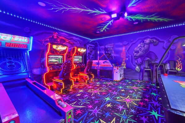 Incredible Marvel game room that includes a basketball machine, a dual Fast and Furious driver game, a Skee-Ball machine, and an air hockey table!