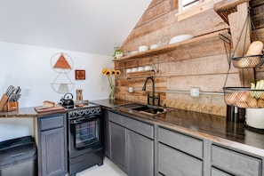 The beautifully designed kitchen with original barn wall and shelf.
