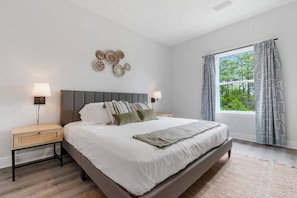 Master Bedroom with King-size bed, smart TV, and en-suite bathroom.