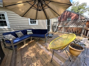 Backyard deck, perfect for lounging and enjoying the sunshine.